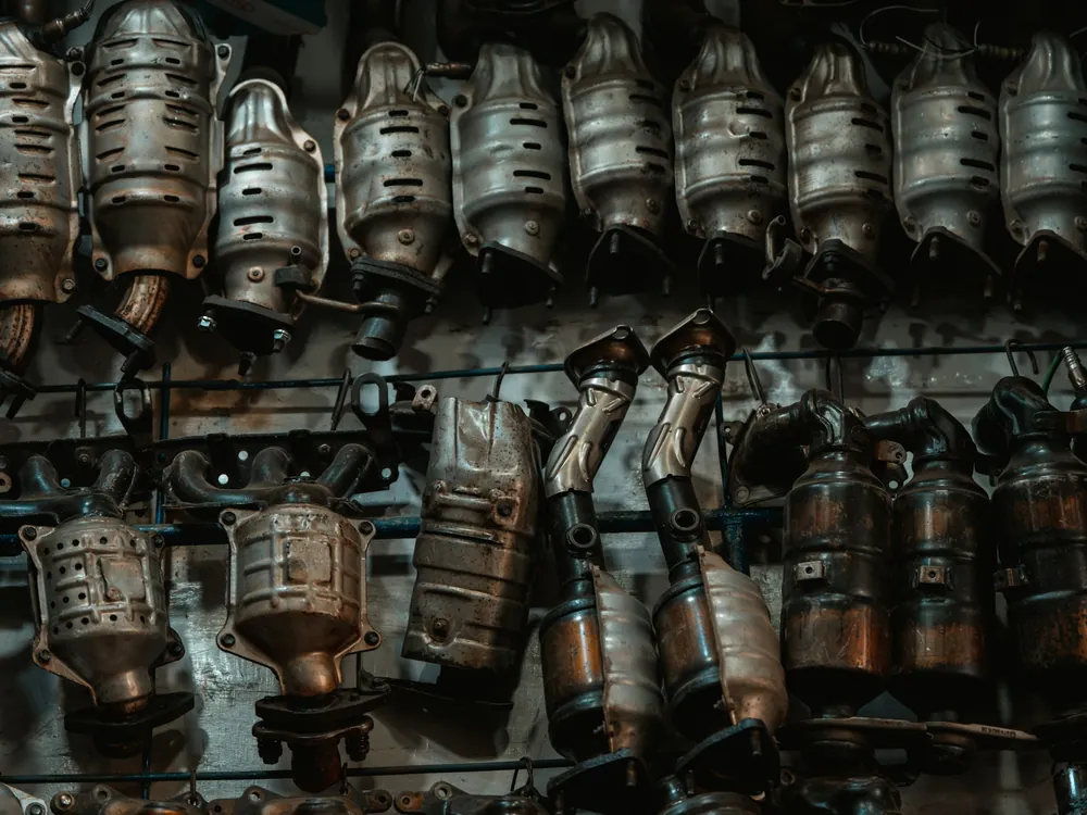 Catalytic converters hanging on a parts wall