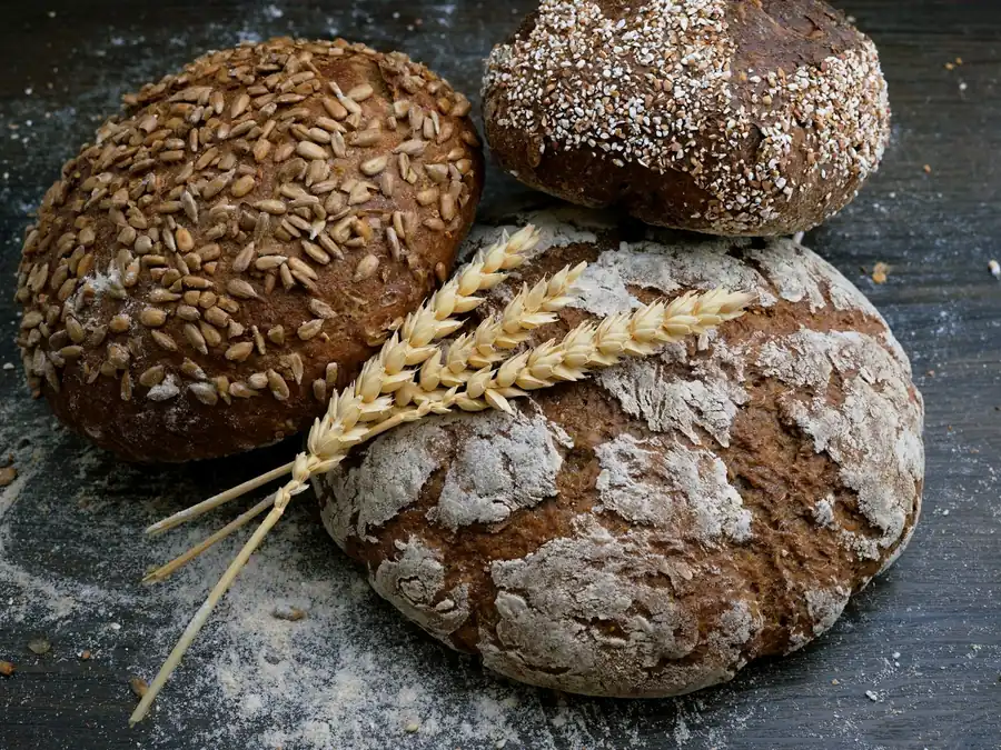 Rustic loaves with seeds and wheat stalks