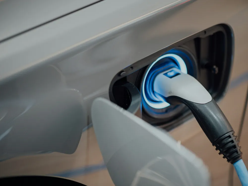 A charging cable plugged into an electric car