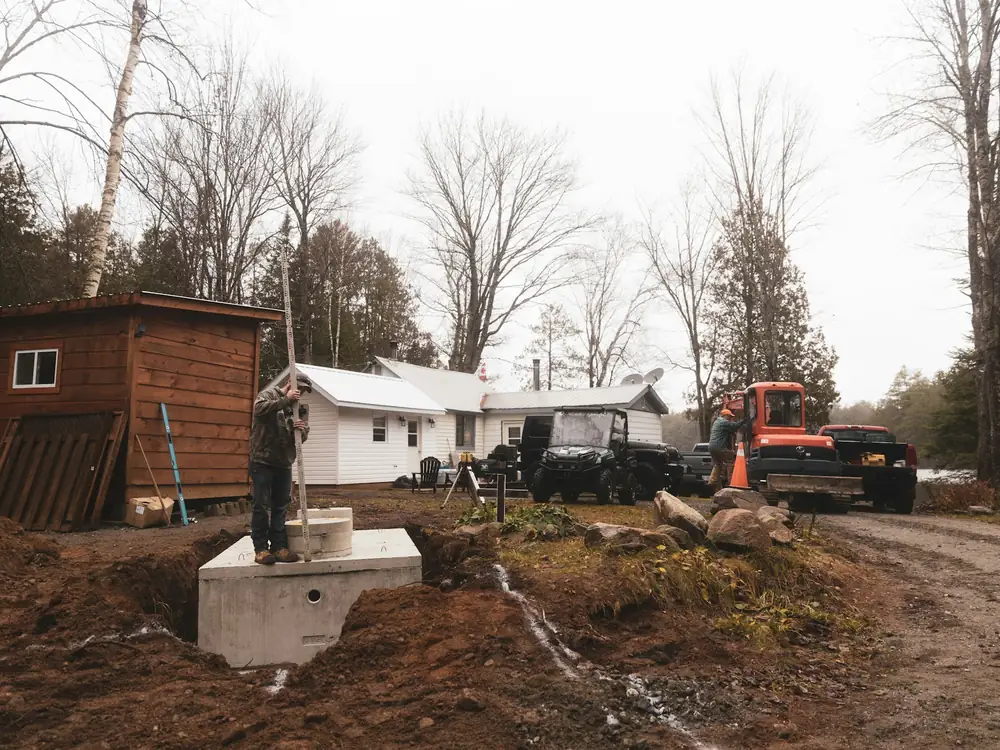 A house with a new septic tank lid in the yard