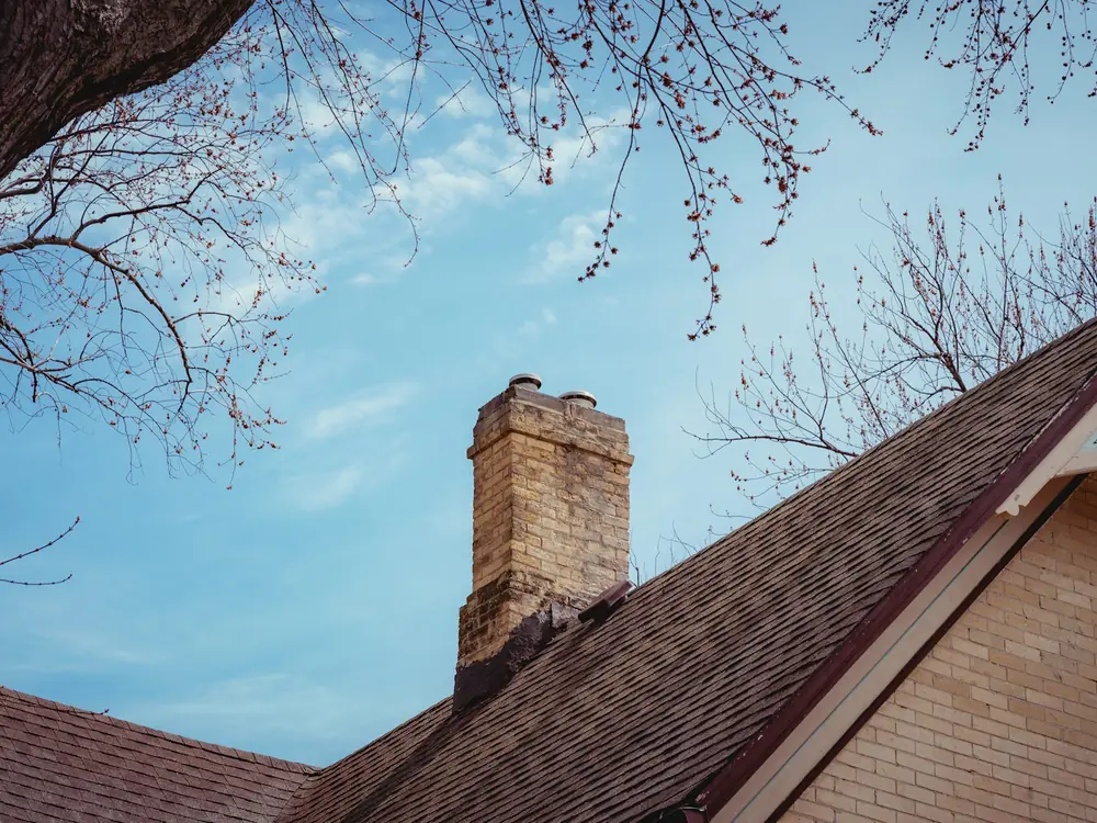 A brick chimney against the sky