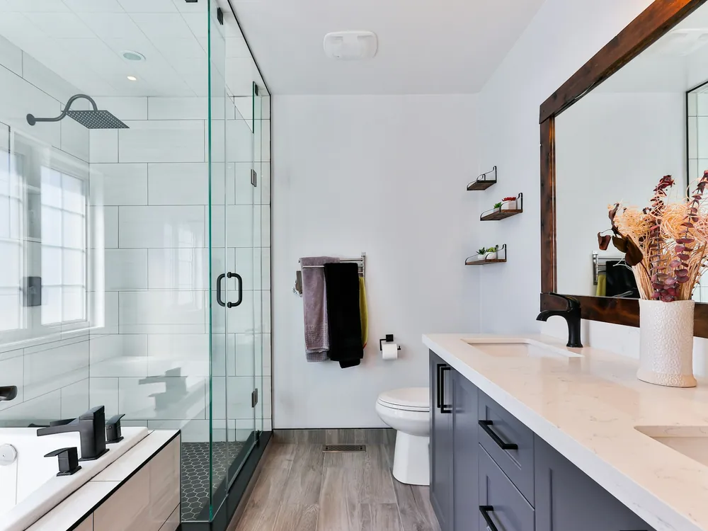 A renovated bathroom with a glass shower