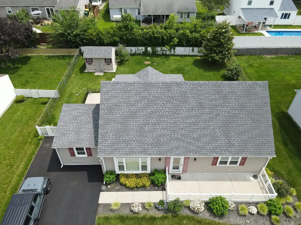 An aerial view of a house with a gray roof